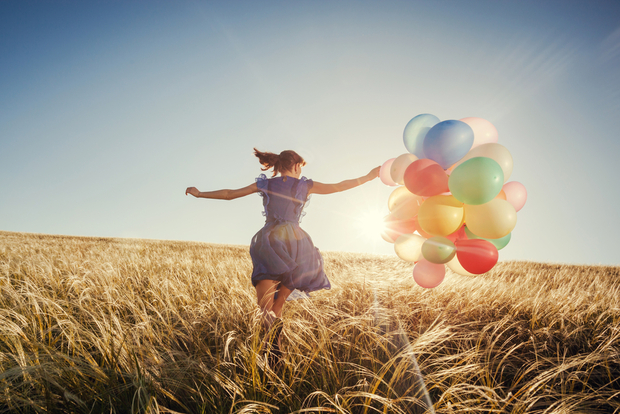 Happy woman running with ballons Happy woman running with ballons