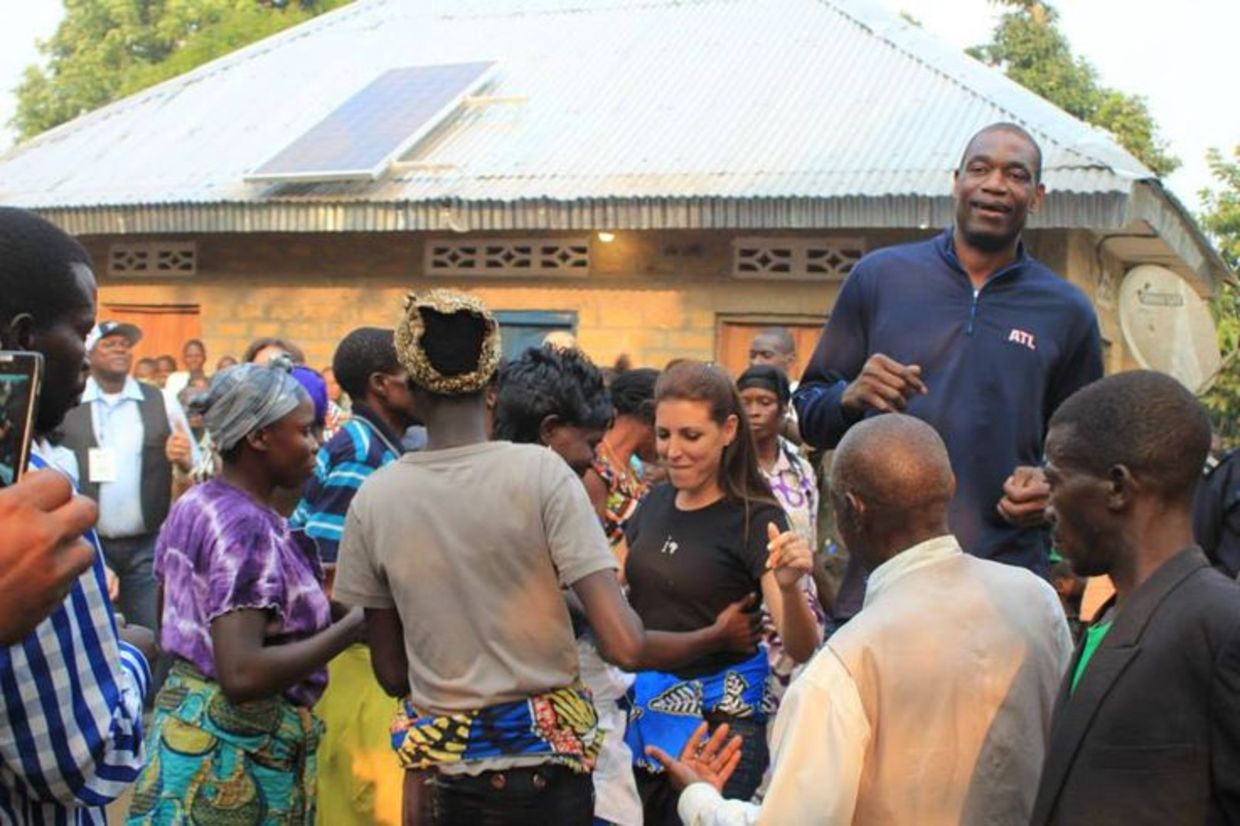 Innovation: Africa's Founder & President, Sivan Ya'ari and Dikembe Mutombo dance with Chief Iba of Bu Village in the Democratic Republic Congo. (Innovation: Africa) Innovation: Africa's Founder & President, Sivan Ya'ari and Dikembe Mutombo dance with Chief Iba of Bu Village in the Democratic Republic Congo. (Innovation: Africa)