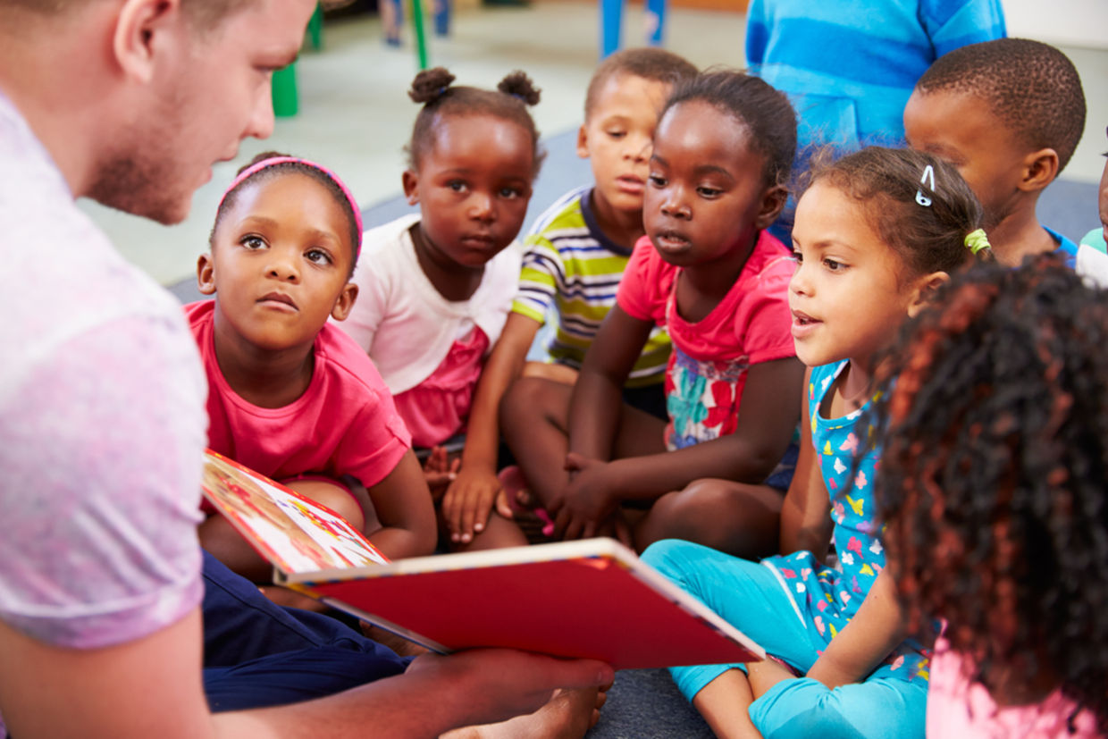 A volunteer reads a book to children. (Shutterstock) A volunteer reads a book to children. (Shutterstock)