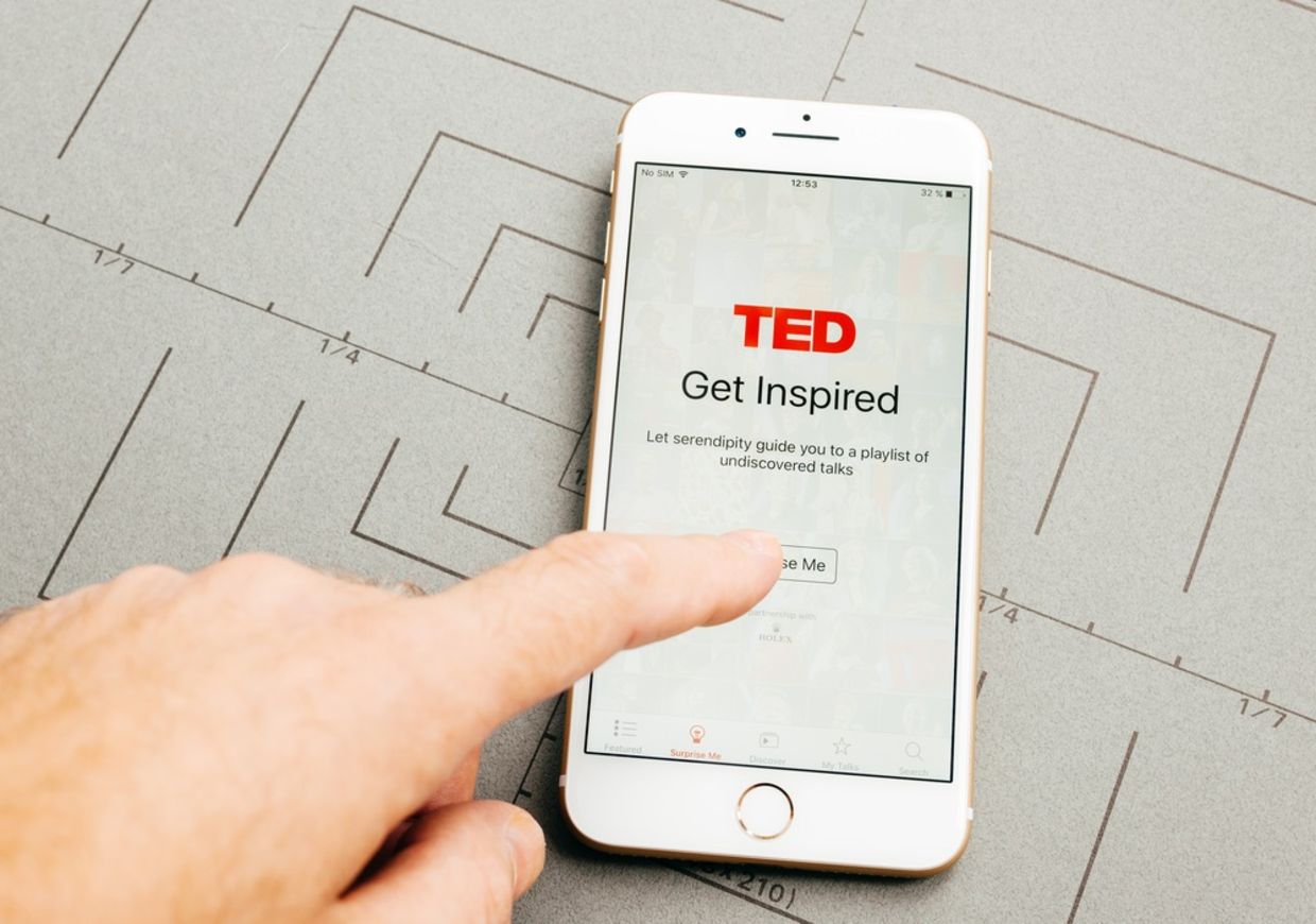 Male hand holding New Apple iPhone 7 Plus after unboxing and testing by installing the app application software TED speaking media app Male hand holding New Apple iPhone 7 Plus after unboxing and testing by installing the app application software TED speaking media app