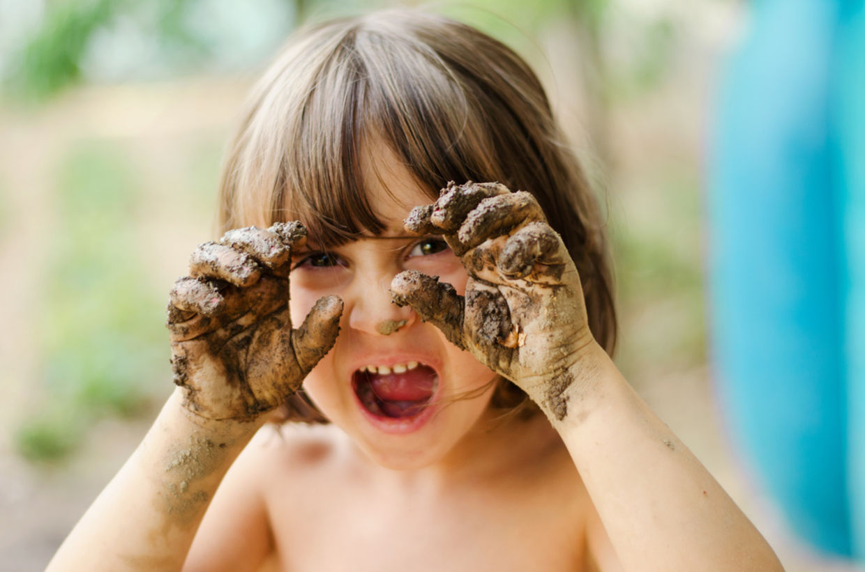 child with muddy hands child with muddy hands