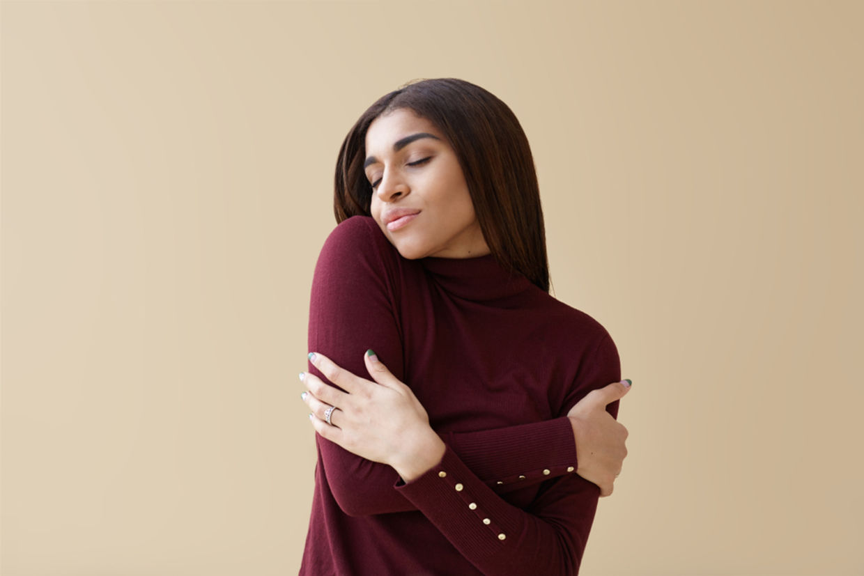 A woman hugging herself A woman hugging herself