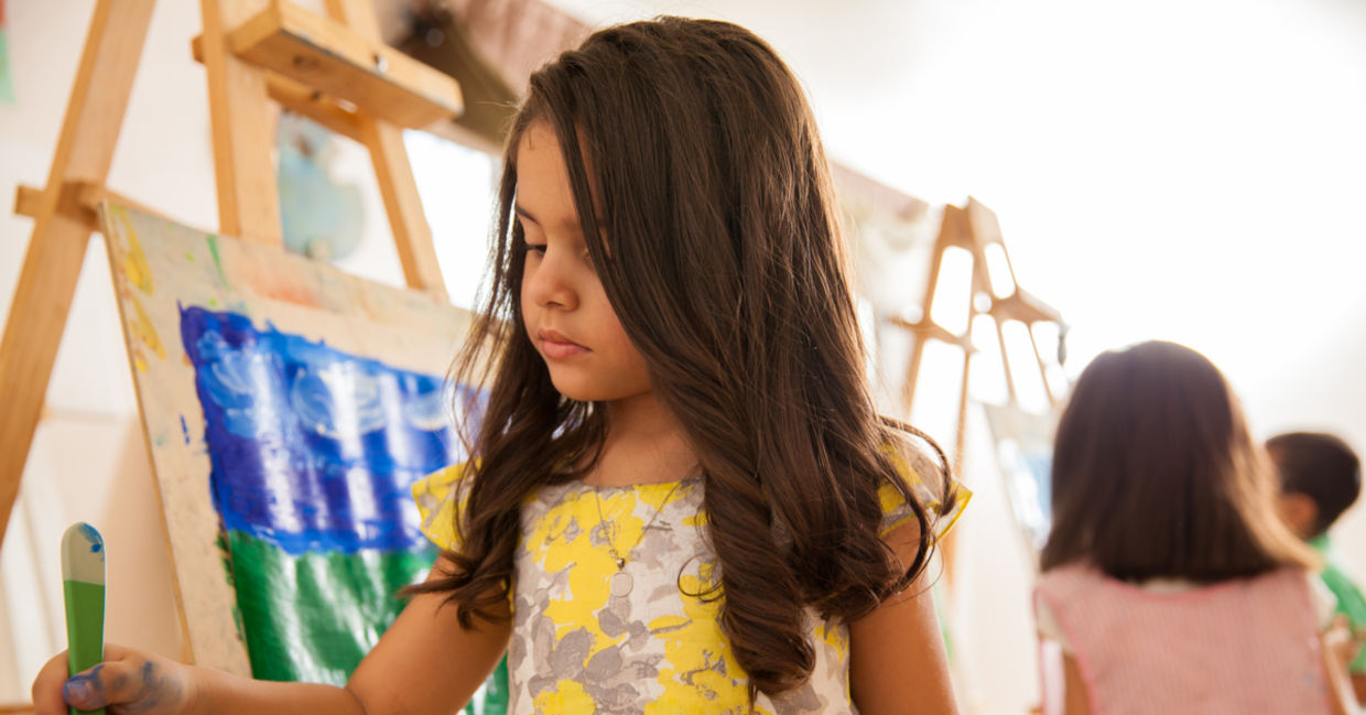Little girl painting with bright colors Little girl painting with bright colors
