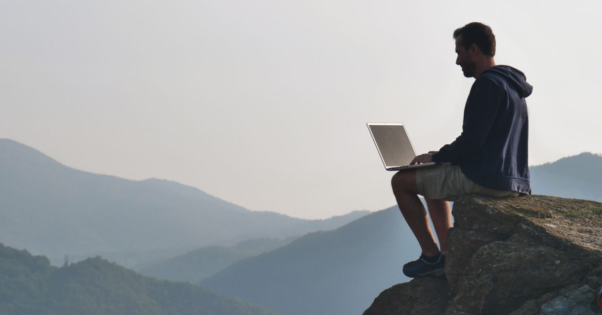 man working outdoors on laptop man working outdoors on laptop