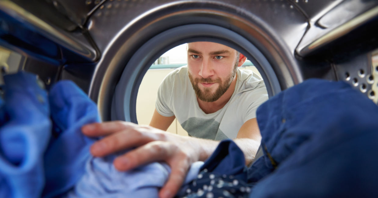 man doing laundry. man doing laundry.