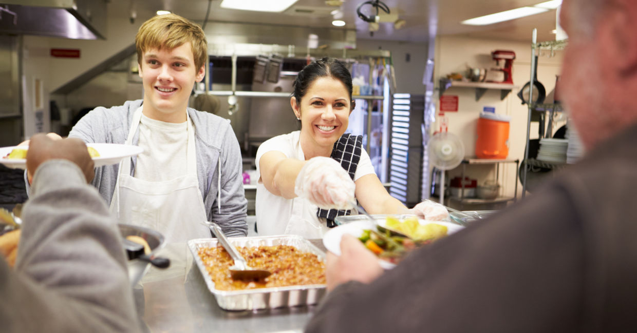 Two volunteers serving dinner Two volunteers serving dinner