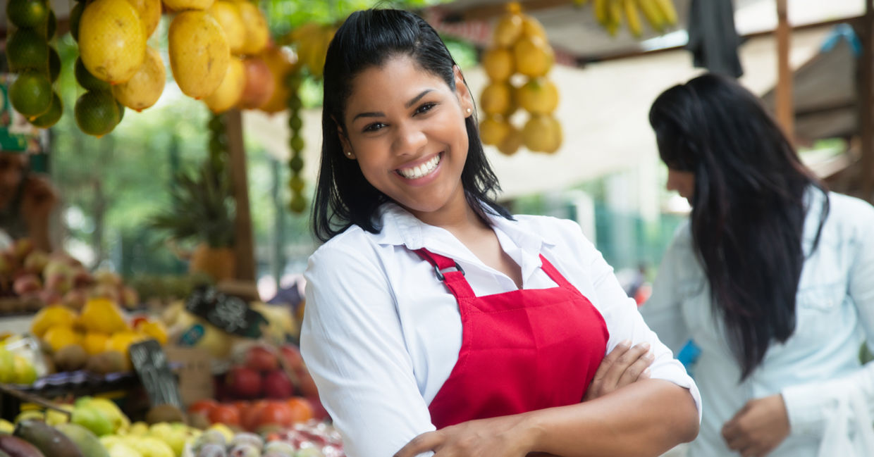 Latin American woman selling fruits and vegetables. Latin American woman selling fruits and vegetables.