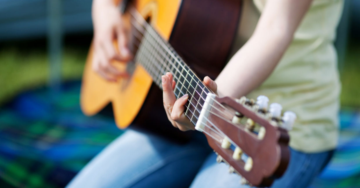 Girl learning how to play a guitar. Girl learning how to play a guitar.
