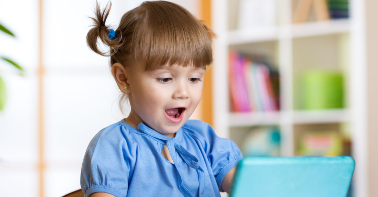 Kid using an educational app. Kid using an educational app.