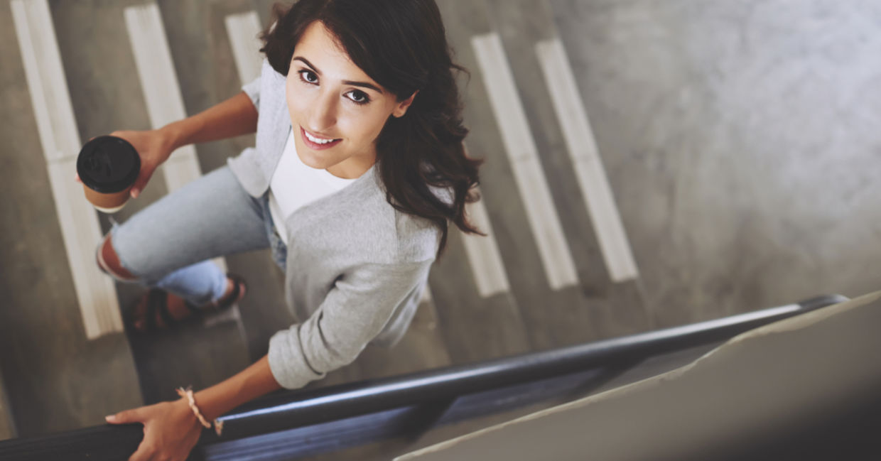 A woman exercises by taking the stairs. A woman exercises by taking the stairs.