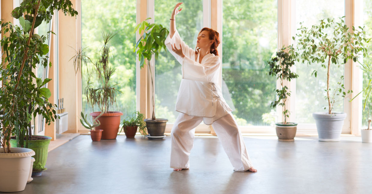 A woman practicing tai chi. A woman practicing tai chi.