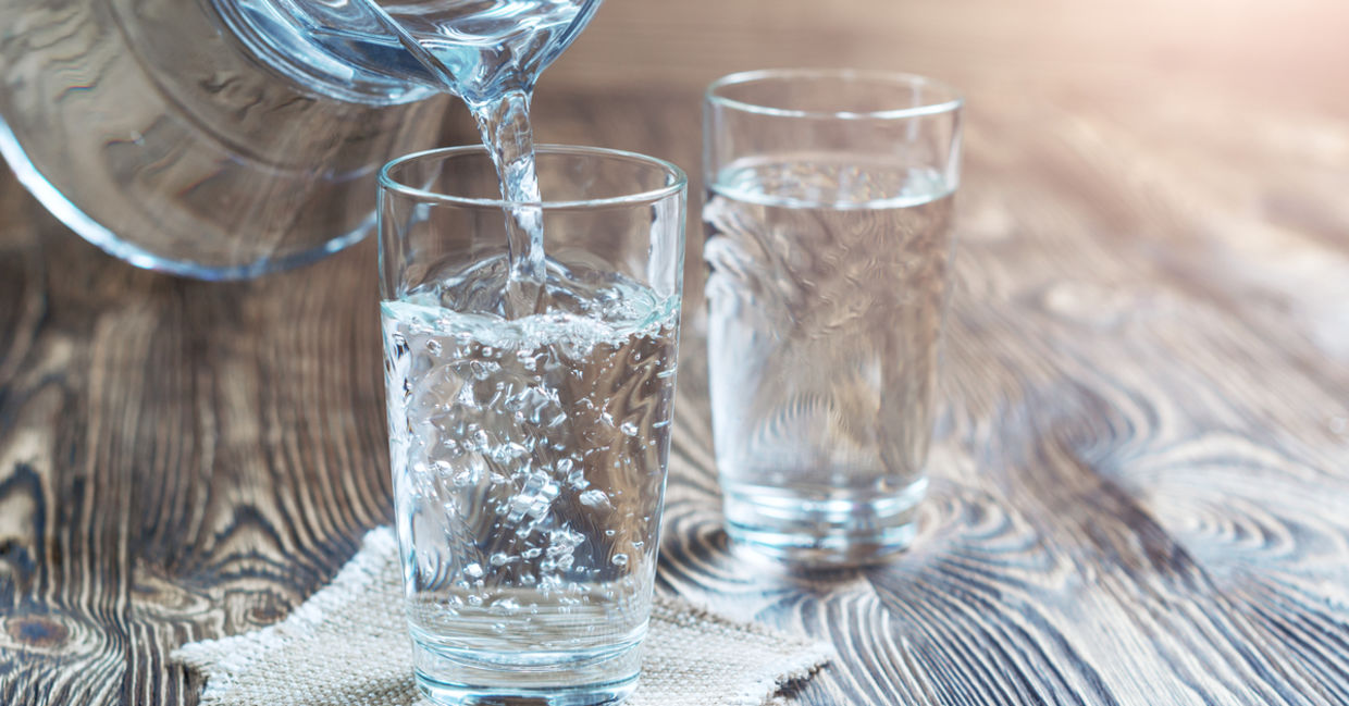 Glass of water on a wooden table Glass of water on a wooden table