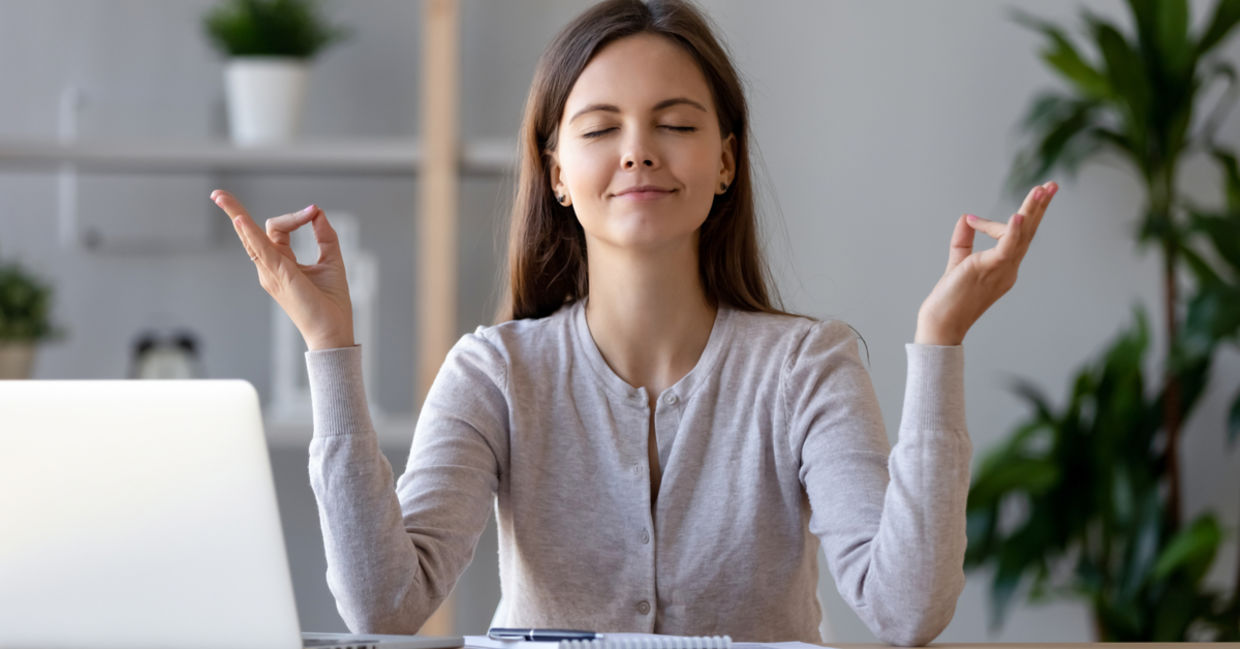 A woman takes a break from work to mediate and regain energy. A woman takes a break from work to mediate and regain energy.