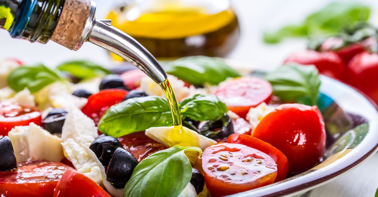 Healthy olive oil on a fresh green salad.
