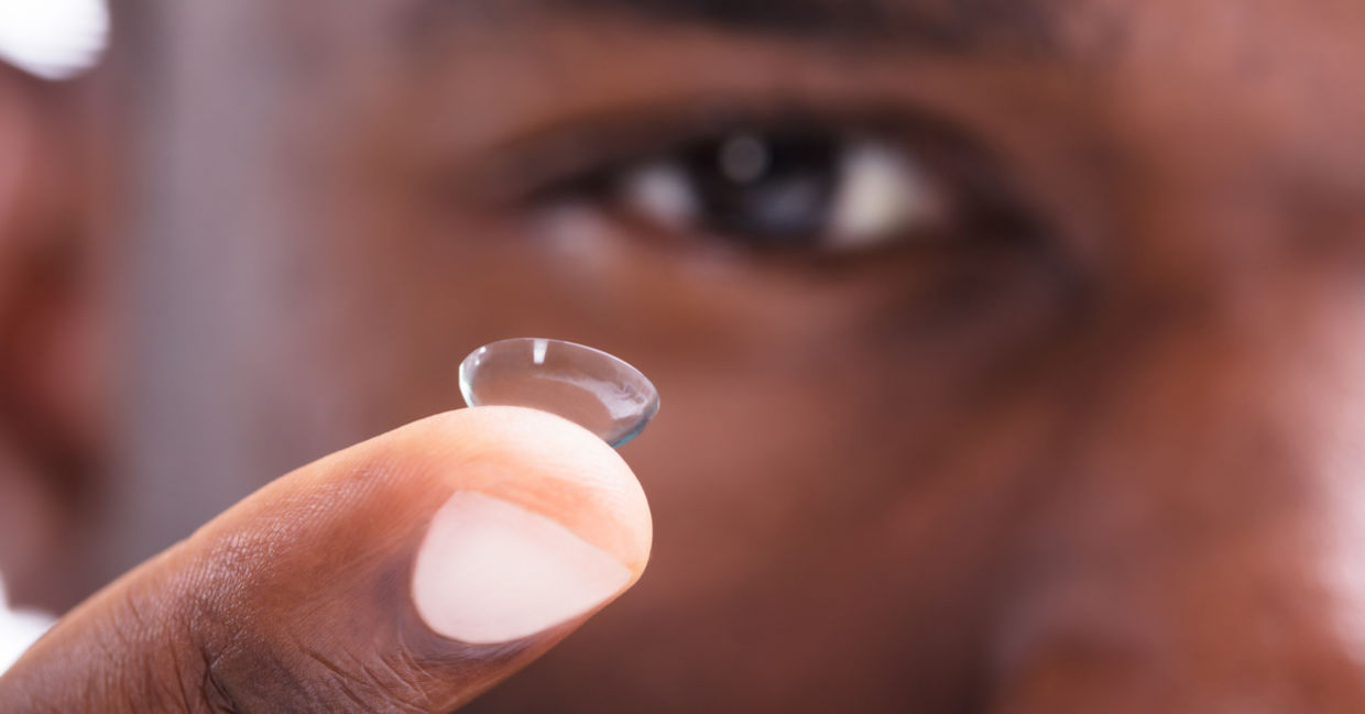 Man removing contacts before swimming. Man removing contacts before swimming.