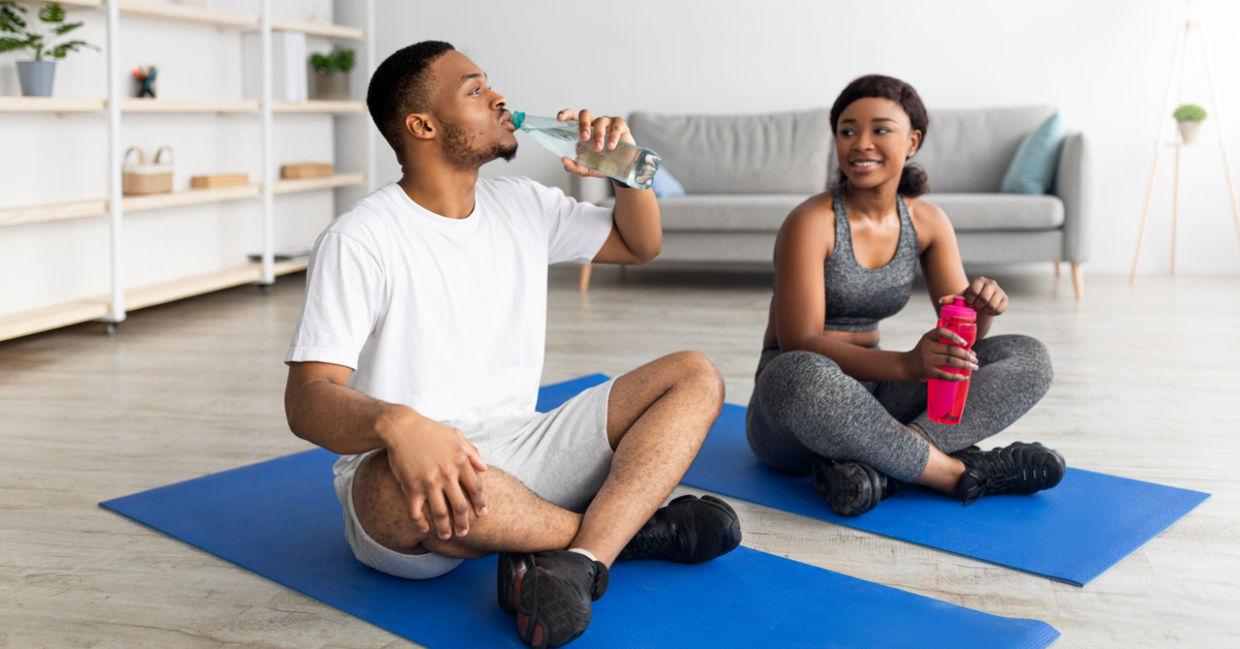 Couple staying hydrated before exercising as a part of daily eye care. Couple staying hydrated before exercising as a part of daily eye care.