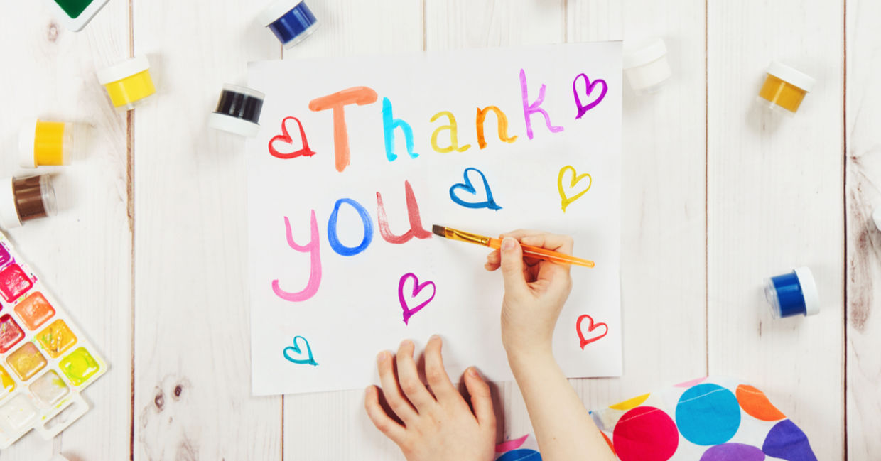A young child is making a thank you card. A young child is making a thank you card.