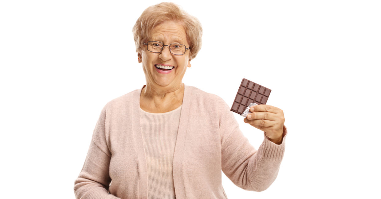 Senior woman enjoying chocolate. Senior woman enjoying chocolate.