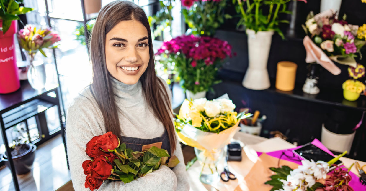 Young woman enjoying learning about flower arranging Young woman enjoying learning about flower arranging