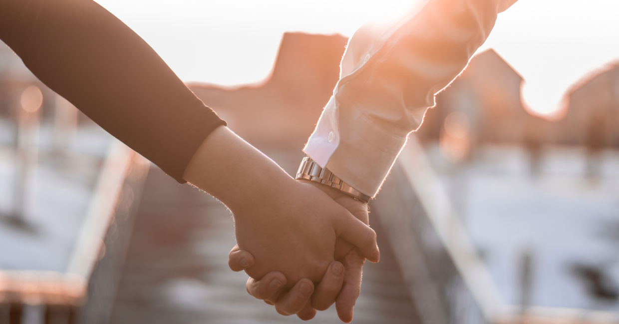 A couple holding hands. A couple holding hands.