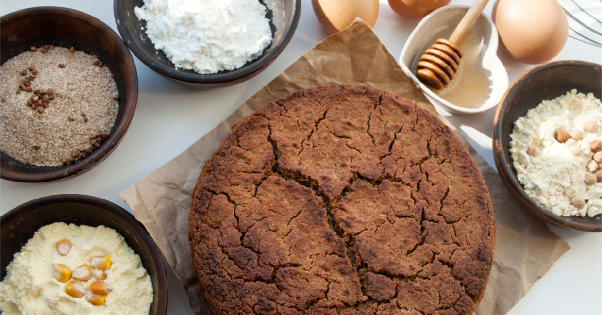 A selection of gluten-free flours beside a healthy freshly baked muffin. A selection of gluten-free flours beside a healthy freshly baked muffin.