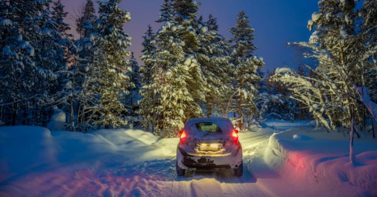 Car traveling on a snowy road. Car traveling on a snowy road.