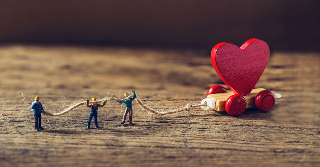 Towing a miniature red heart representing starting small with good deeds. Towing a miniature red heart representing starting small with good deeds.