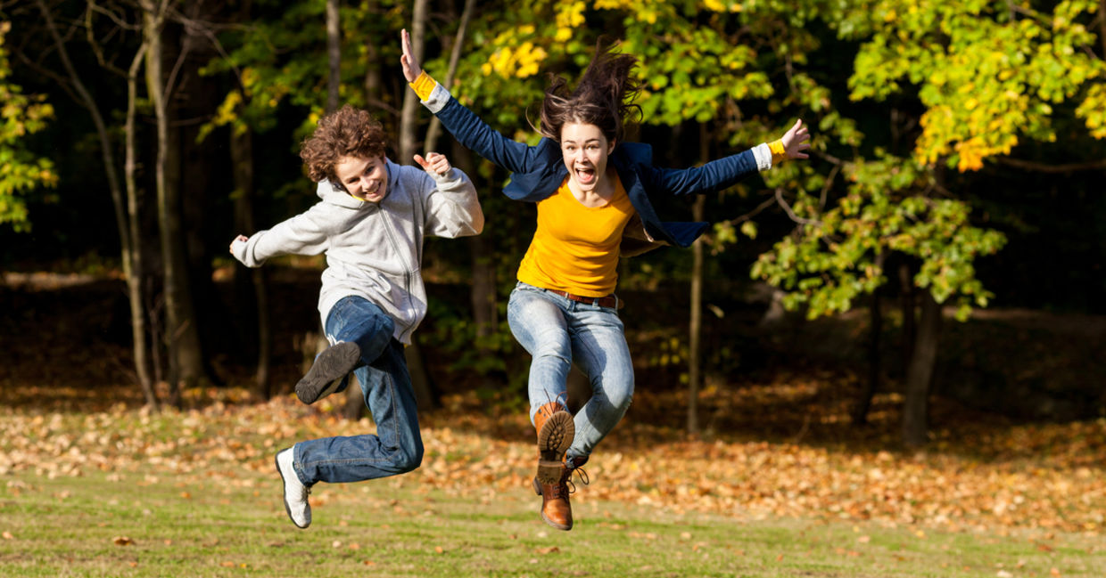 Girl and boy jumping and enjoying the outdoors. Girl and boy jumping and enjoying the outdoors.