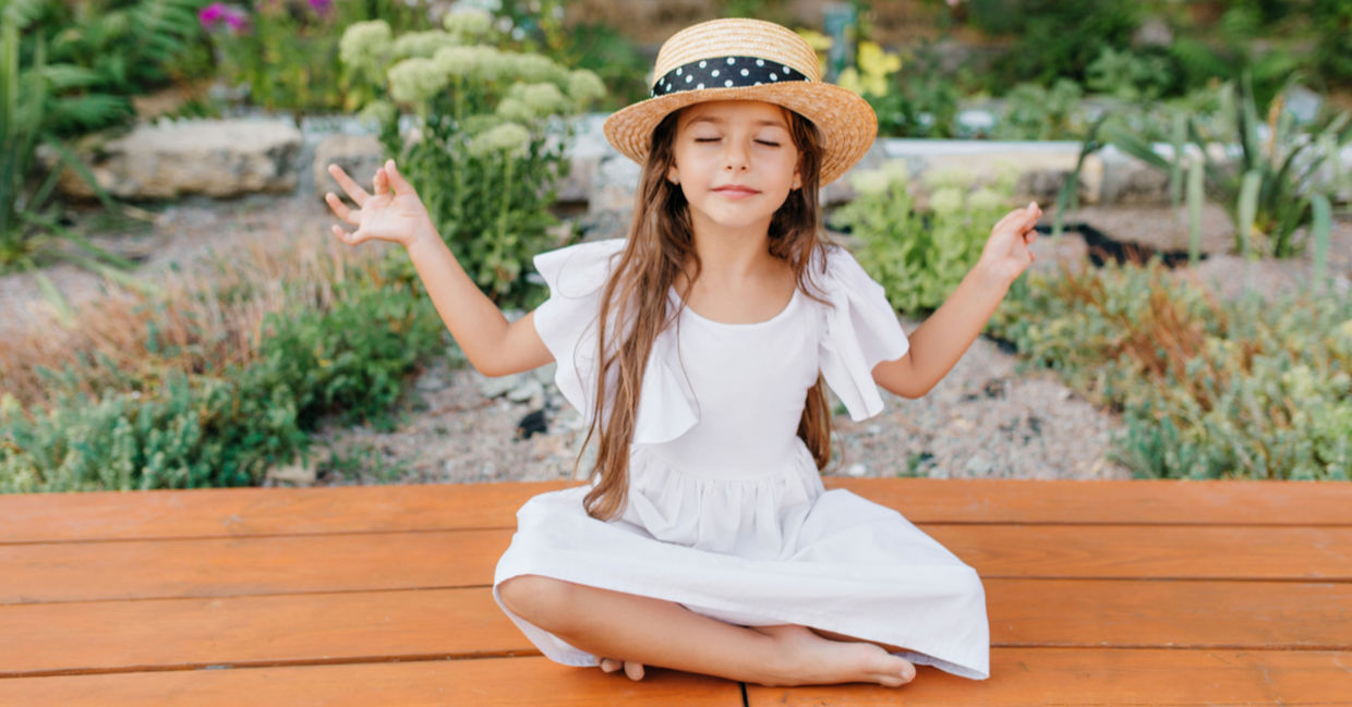 Girl relaxing near a flower bed. Girl relaxing near a flower bed.