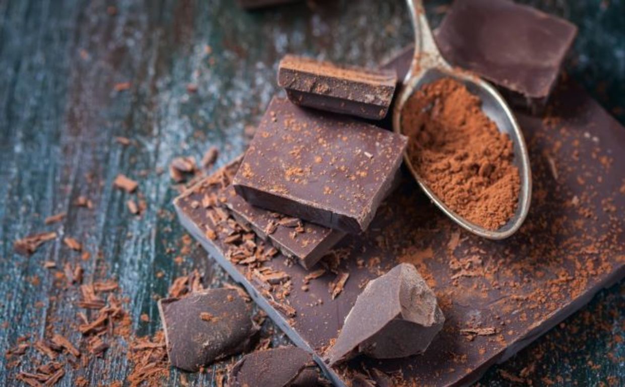 dark chocolate and cocoa powder on a spoon dark chocolate and cocoa powder on a spoon
