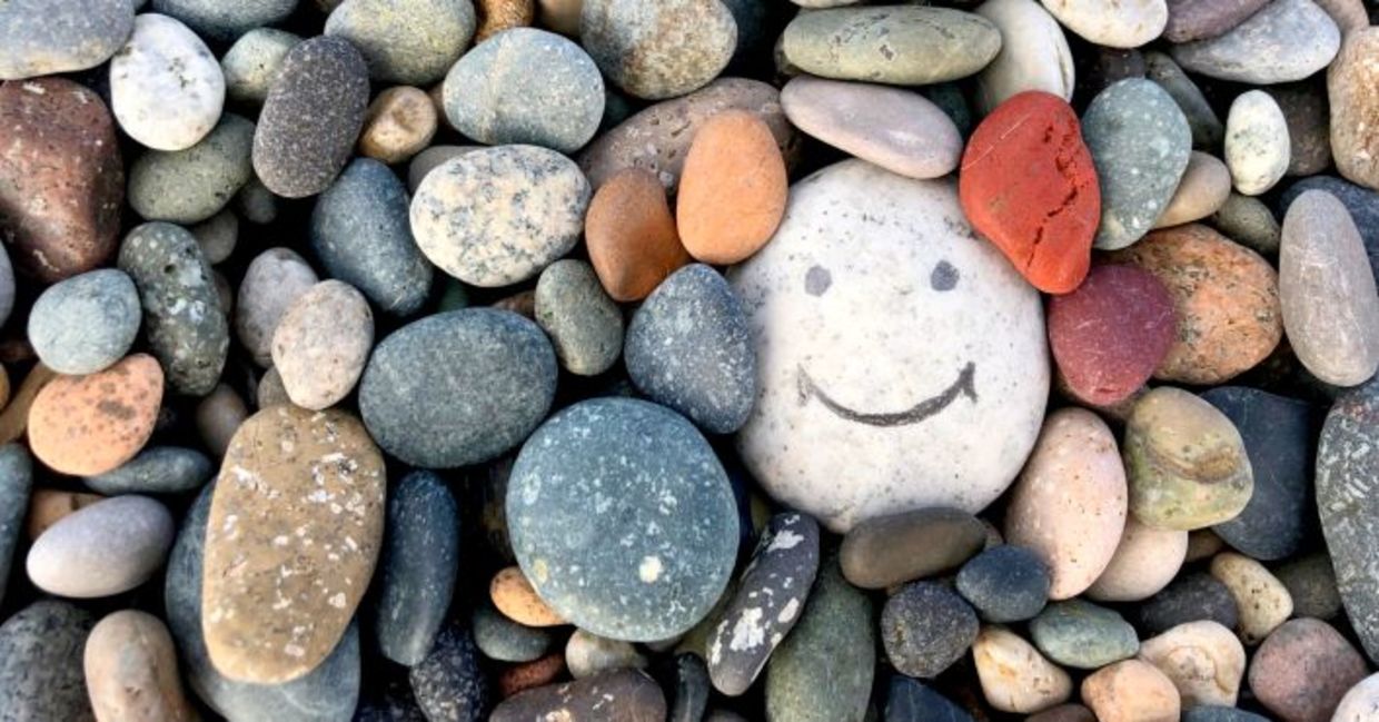 Stone with a painted smile to illustrate kindness. Stone with a painted smile to illustrate kindness.