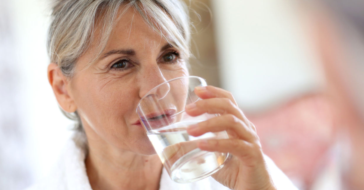 Woman drinking water in the morning. Woman drinking water in the morning.