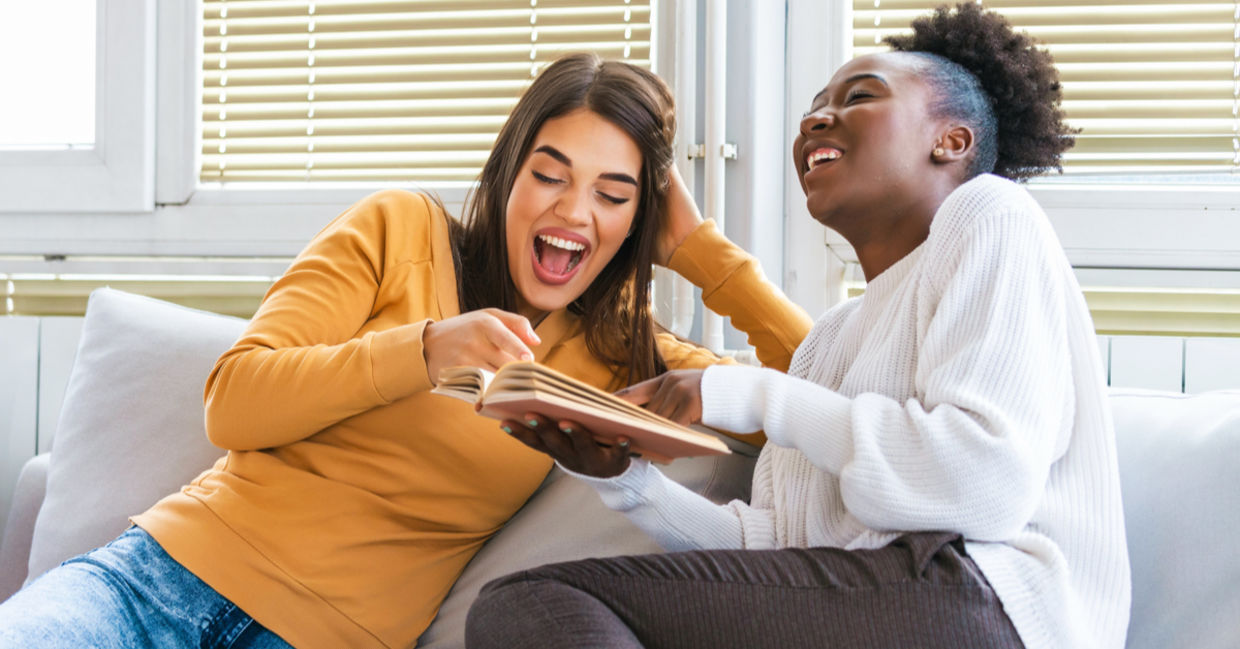 Two women laughing while learning together. Two women laughing while learning together.