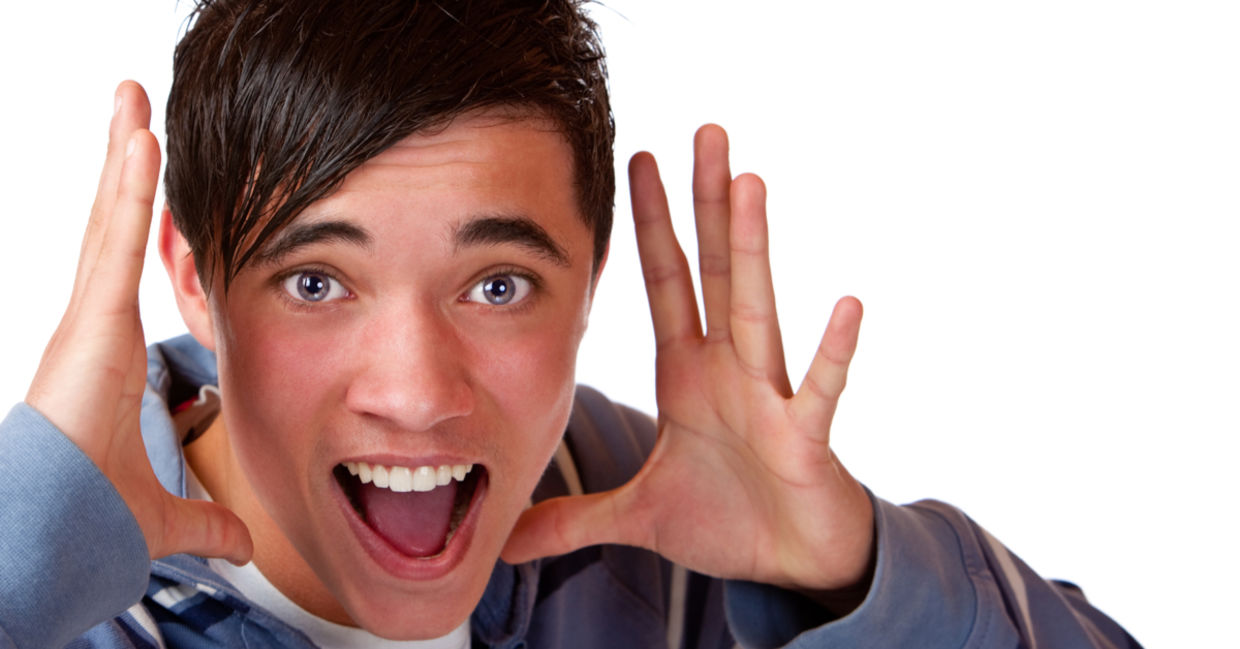 Teen holding his hands by his head and announcing interesting news. Teen holding his hands by his head and announcing interesting news.