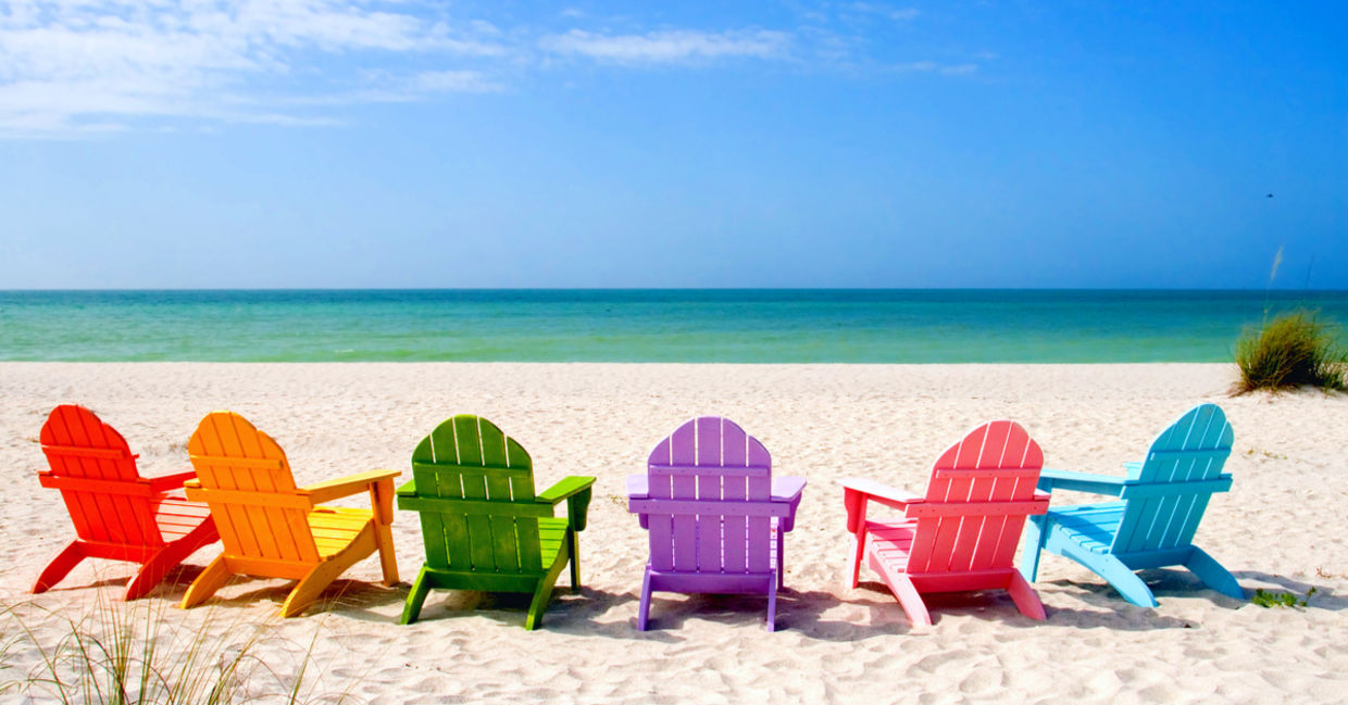 Colored chairs on a scenic shore suggesting positive potential. Colored chairs on a scenic shore suggesting positive potential.