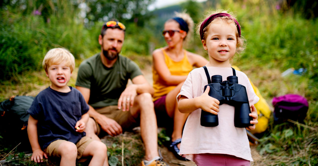 Family with small children hiking outdoors in summer. Family with small children hiking outdoors in summer.