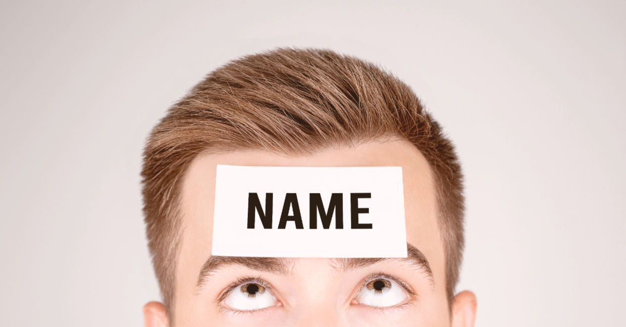 Man looking at paper with Name pasted on his forehead. Man looking at paper with Name pasted on his forehead.