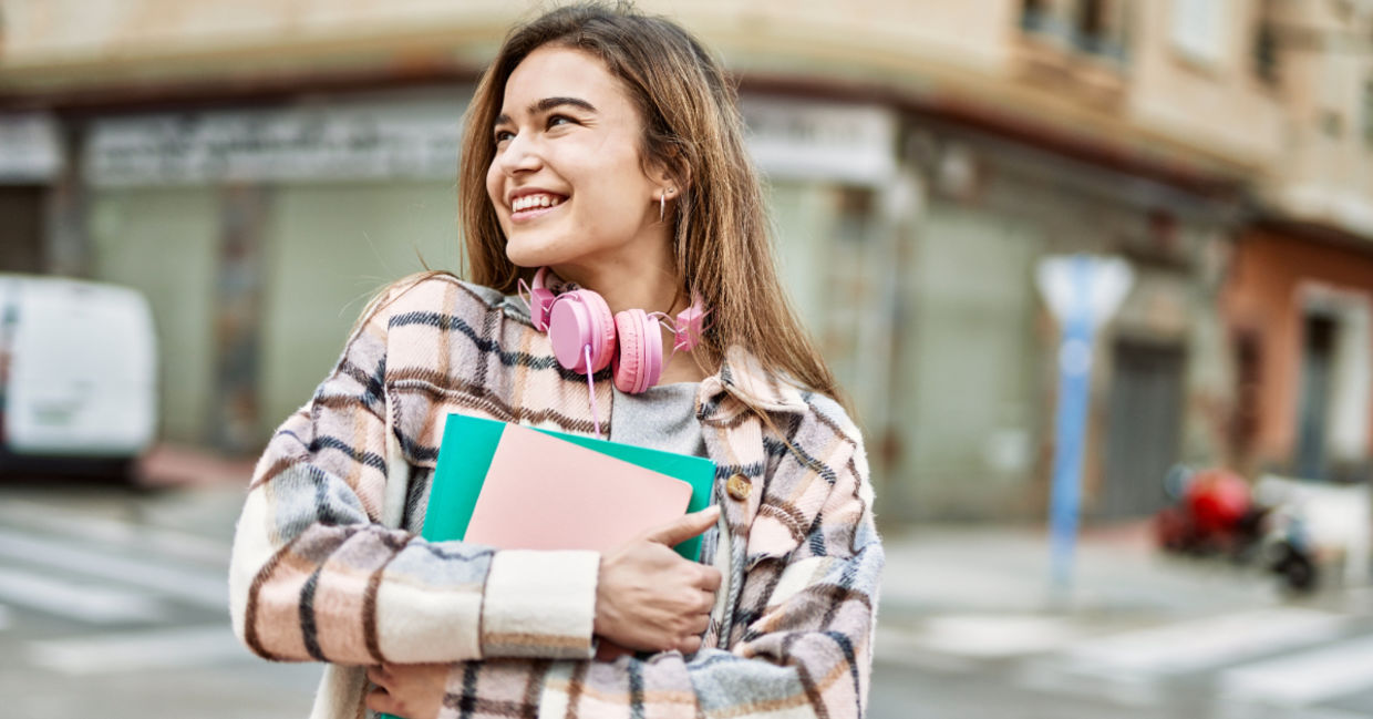 A young woman holding books. A young woman holding books.