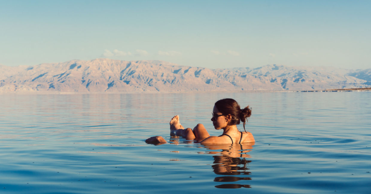 Floating in the medicinal healing waters of the Dead Sea. Floating in the medicinal healing waters of the Dead Sea.