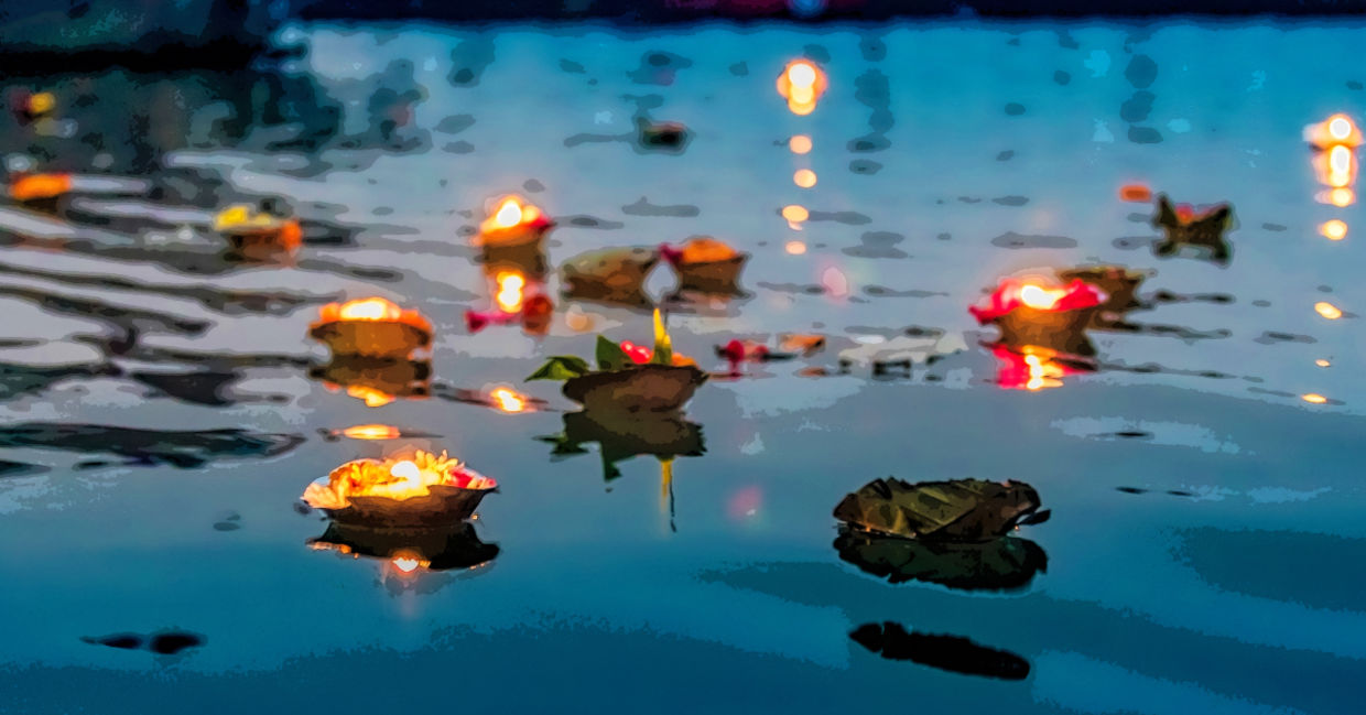 Light and flower spiritual offerings in the Ganges River. Light and flower spiritual offerings in the Ganges River.
