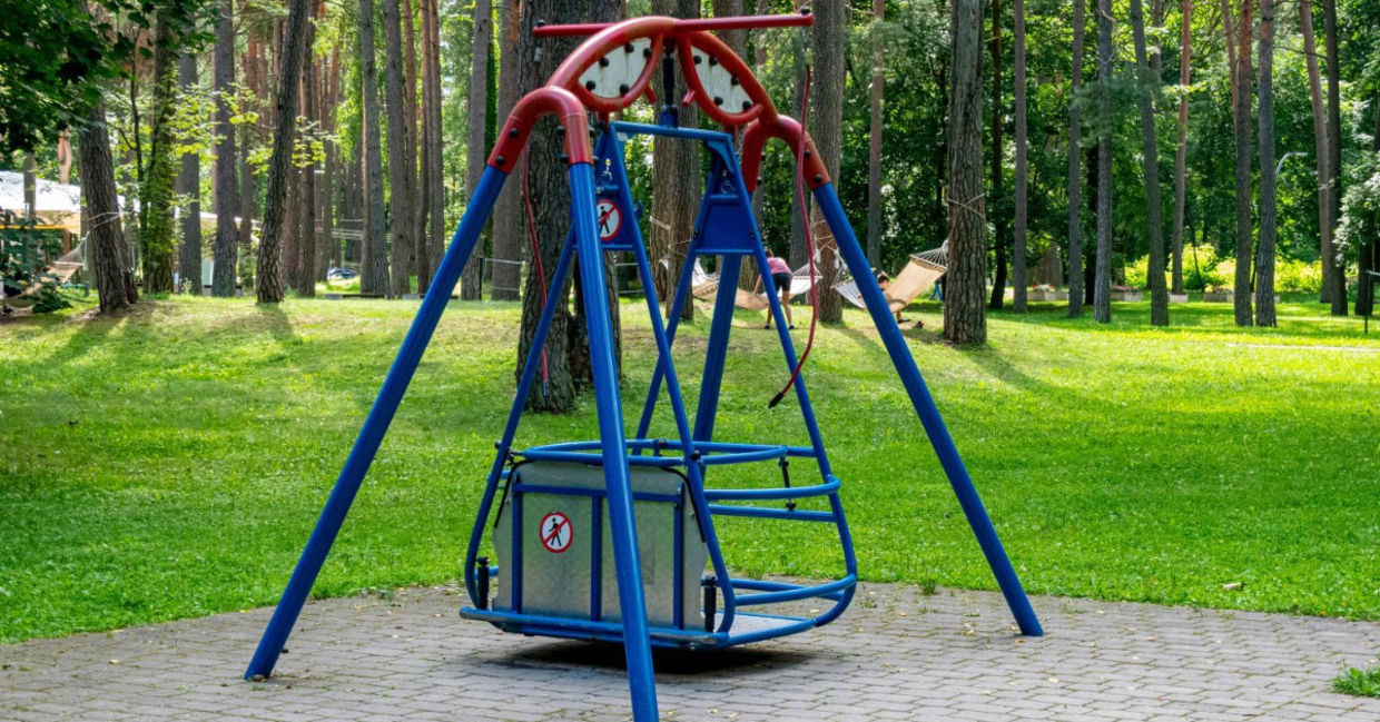 Wheelchair accessible swing in a park. Wheelchair accessible swing in a park.