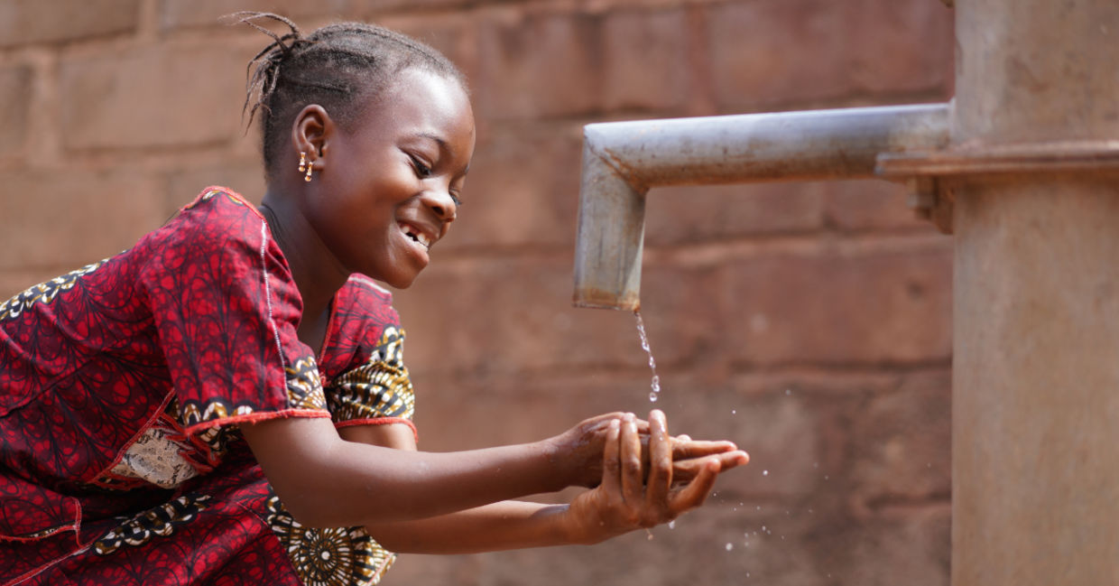 An African boy washing his hands. An African boy washing his hands.