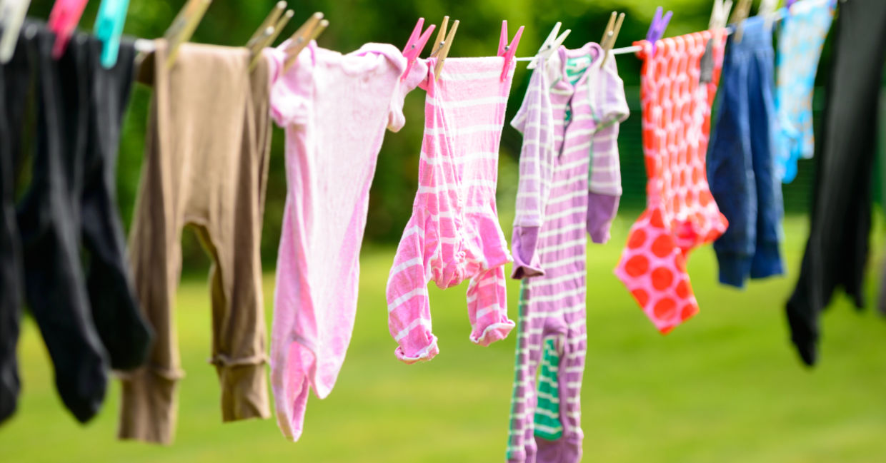 Hanging clothes on a line to dry outside. Hanging clothes on a line to dry outside.