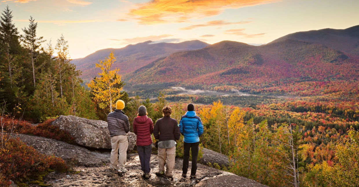 A family hiking at the Adirondacks in late autumn stops to enjoy the view. A family hiking at the Adirondacks in late autumn stops to enjoy the view.