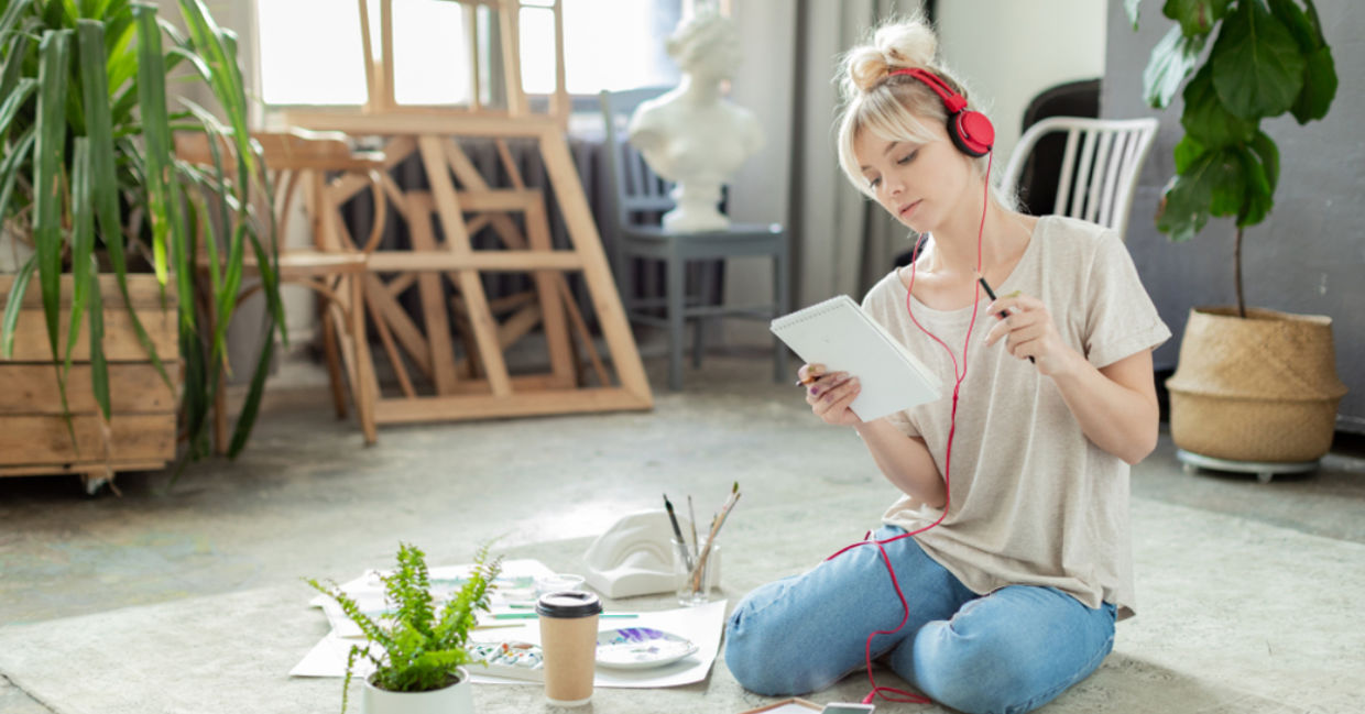 Creative woman listening to music while working. Creative woman listening to music while working.