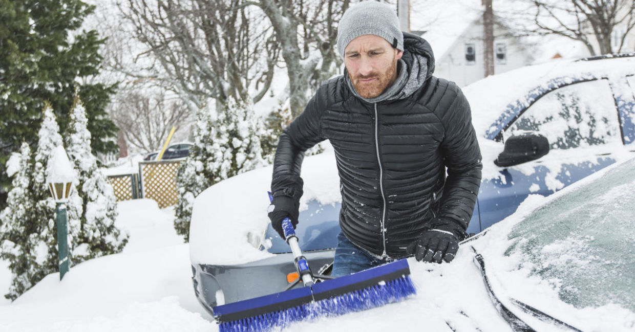 Man cleaning off neighbor's snowbound car, Man cleaning off neighbor's snowbound car,