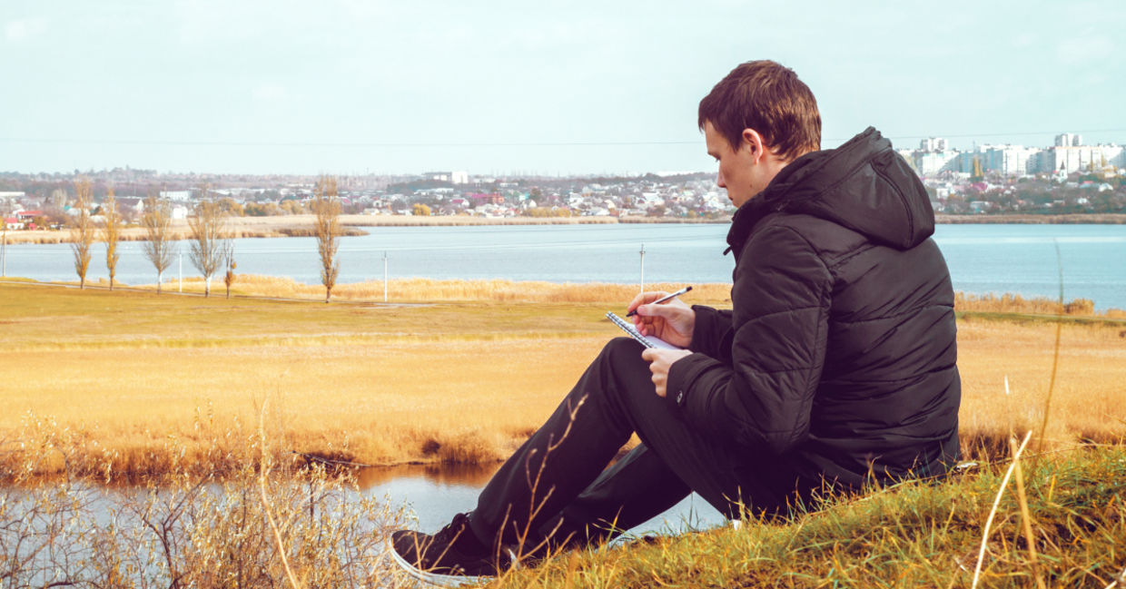 A young man writing a poem. A young man writing a poem.