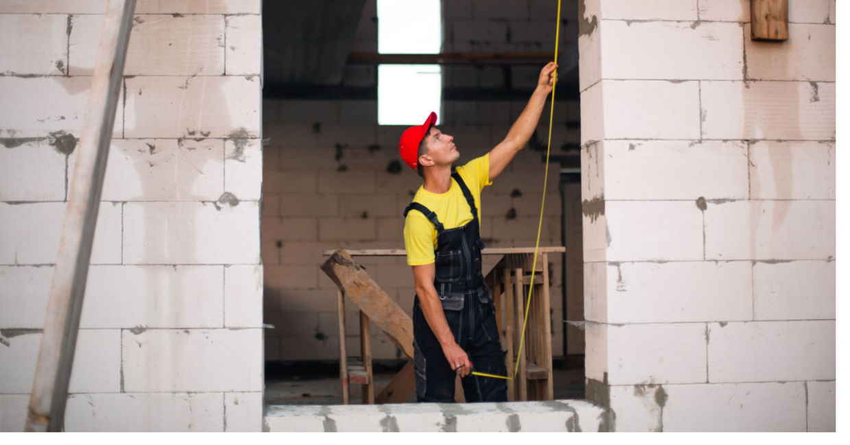 Construction worker using concrete blocks. Construction worker using concrete blocks.