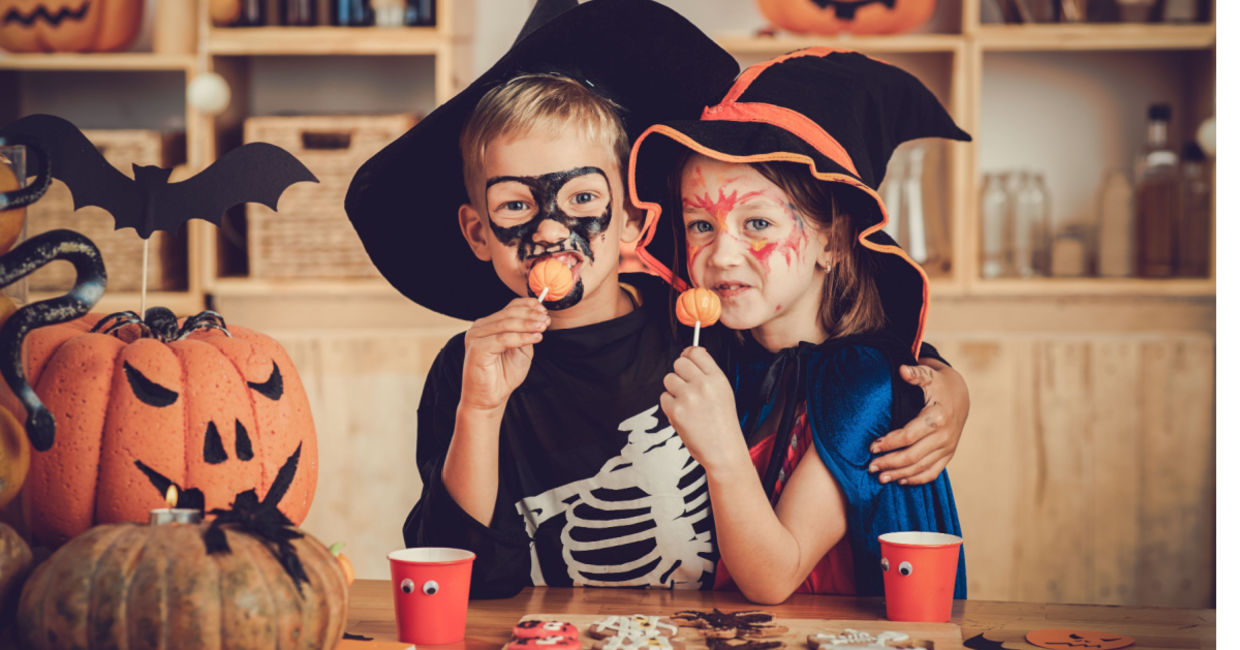 Costumed children enjoying festive foods. Costumed children enjoying festive foods.