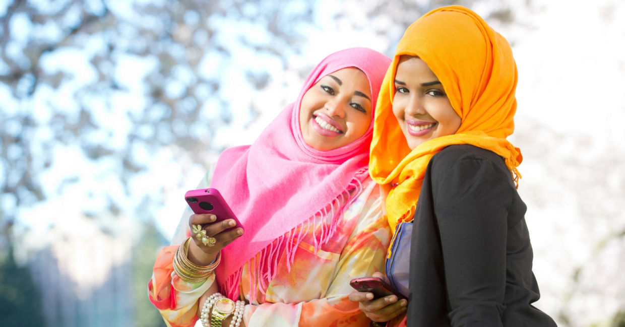 Two young Somali women using an app. Two young Somali women using an app.